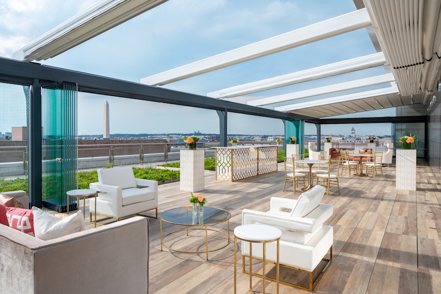 Rooftop looking out over the National Mall with wooden floors and gold furniture