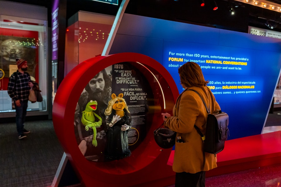A museum-goer looks at Miss Piggy and Kermit from the Muppets on display at the National Museum of American History. 