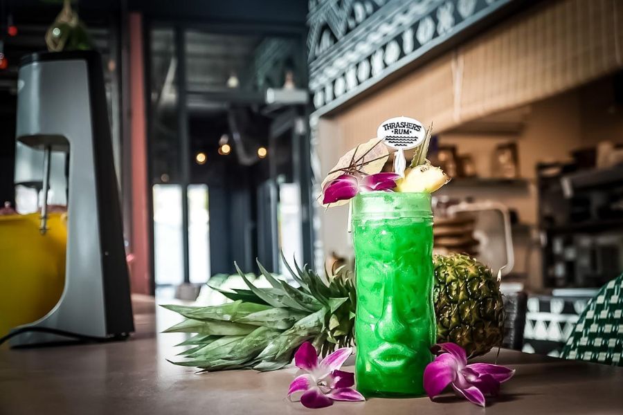 Green cocktail in tiki glass at Tiki TNT bar