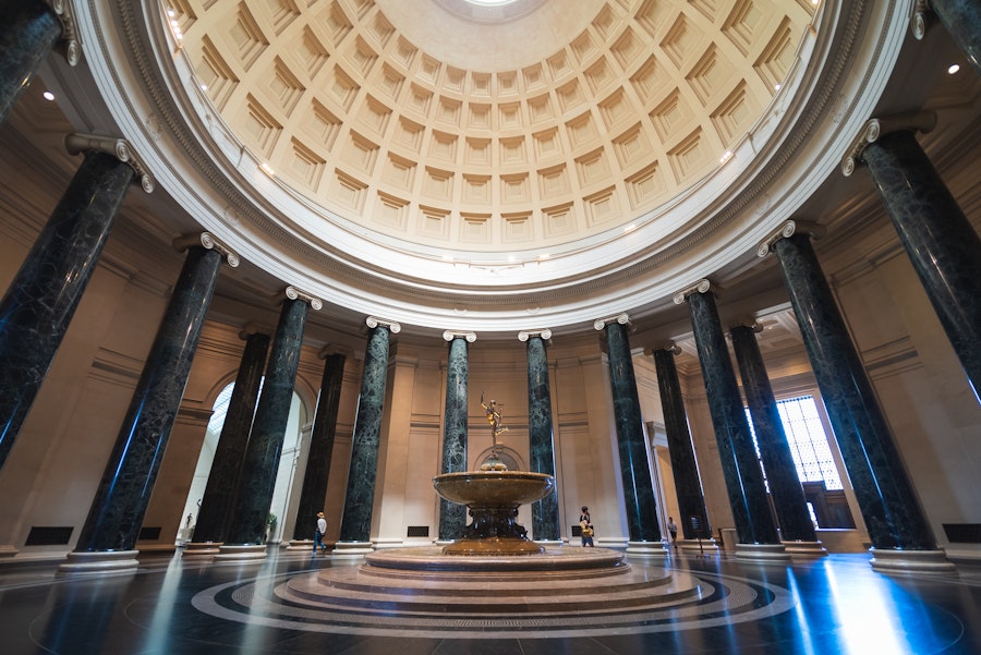 The grand rotunda at the National Gallery of Art with its fountain and marble columns.