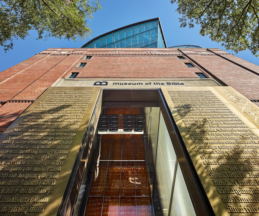 The golden, exterior doors of the Museum of the Bible on a sunny day. 