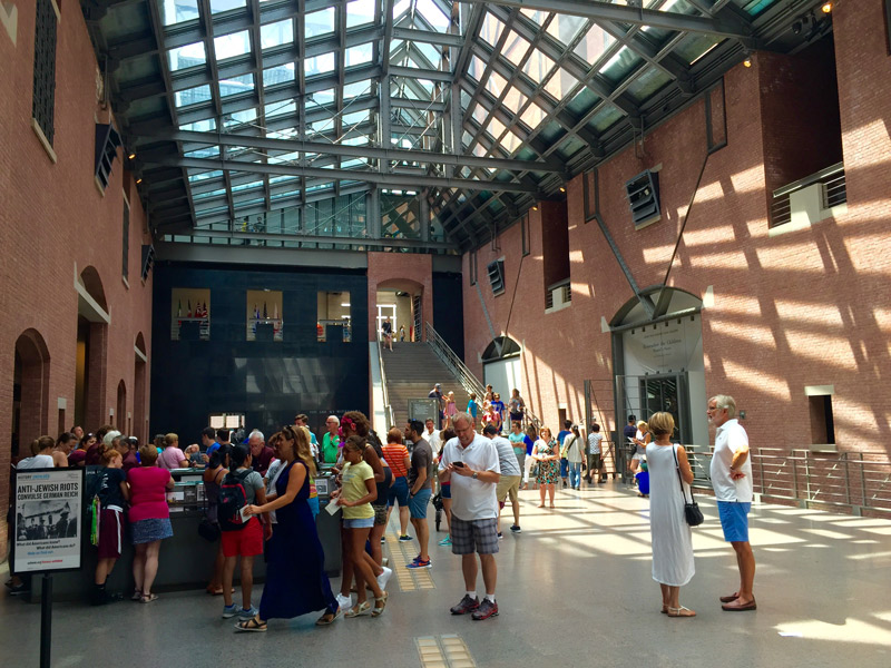 Visitors stand in the atrium of the United States Holocaust Memorial Museum in DC. 